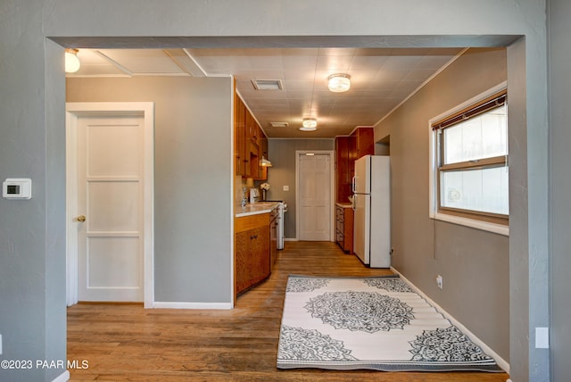 hall with light hardwood / wood-style flooring