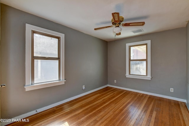 empty room featuring ceiling fan and light hardwood / wood-style flooring