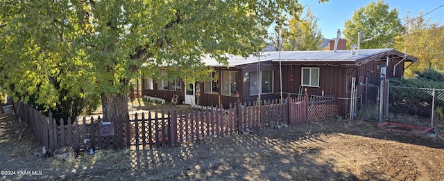 12995 E Main St, Dewey-Humboldt, AZ 86329 - ranch-style house featuring a chimney, board and batten siding, and a metal roof