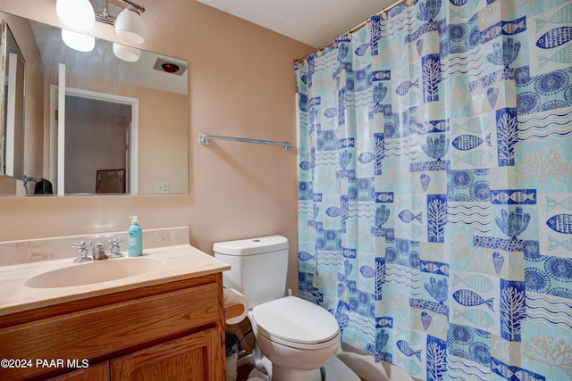 bathroom featuring vanity, toilet, and walk in shower