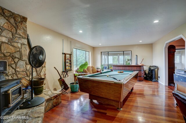 recreation room featuring a wood stove, light hardwood / wood-style floors, and pool table