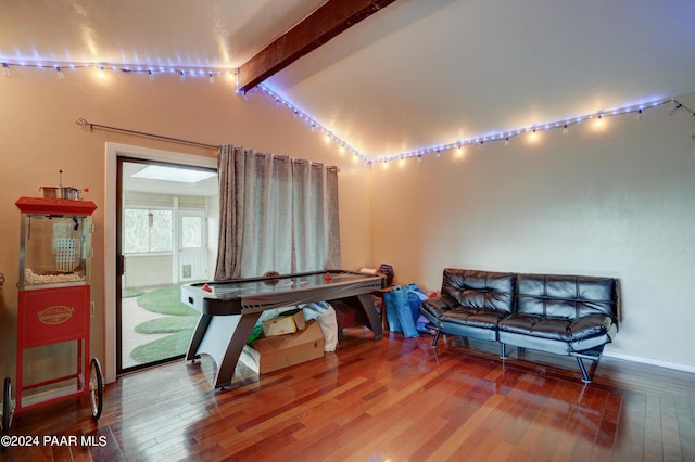 interior space featuring hardwood / wood-style floors and lofted ceiling with beams