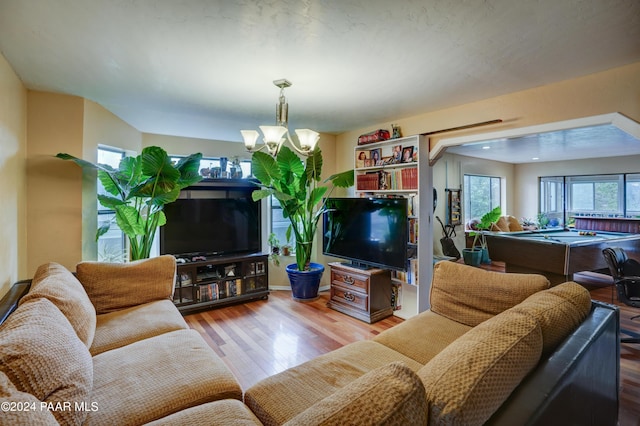 living room with a chandelier, hardwood / wood-style flooring, and pool table