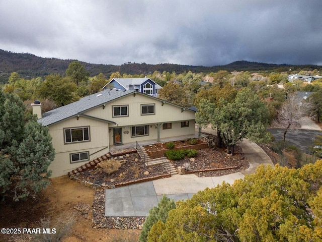 1703 Thunderbird Cir, Prescott, AZ 86303 - back of property with a chimney and a forest view