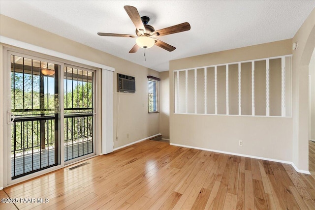 416 Hillcrest Dr, Prescott, AZ 86303 - empty room featuring a wall mounted AC, ceiling fan, hardwood / wood-style flooring, and baseboards