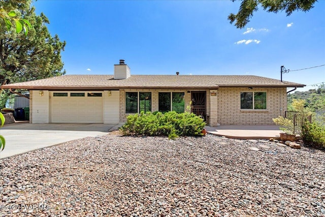 416 Hillcrest Dr, Prescott, AZ 86303 - ranch-style home featuring a garage, concrete driveway, a chimney, and a shingled roof