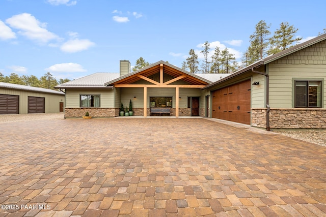 1700 S Sheriffs Posse Trl, Prescott, AZ 86303 - view of front of house with a garage, stone siding, driveway, and a chimney
