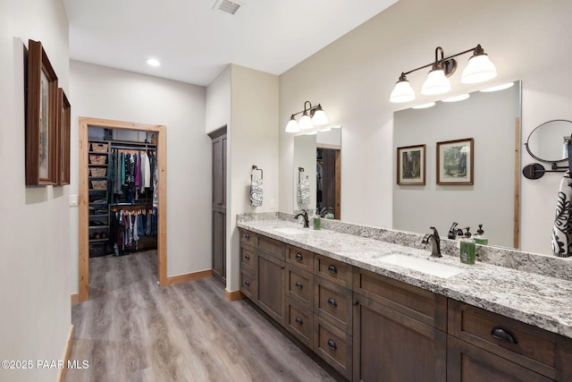1700 S Sheriffs Posse Trl, Prescott, AZ 86303 - full bathroom featuring visible vents, a sink, wood finished floors, double vanity, and a spacious closet