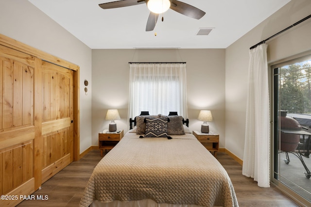 bedroom with dark hardwood / wood-style floors, access to exterior, and ceiling fan