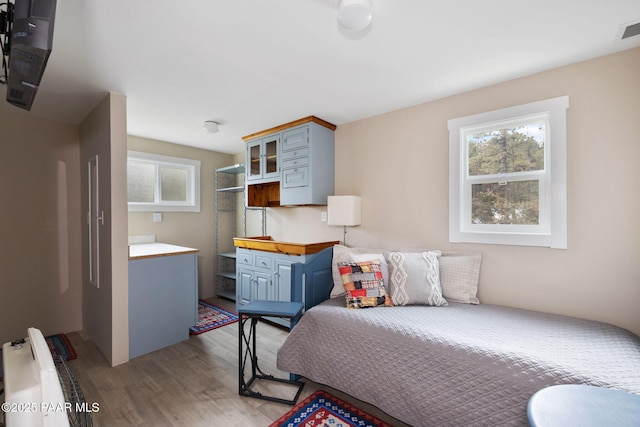 1700 S Sheriffs Posse Trl, Prescott, AZ 86303 - bedroom featuring radiator, wood finished floors, and visible vents