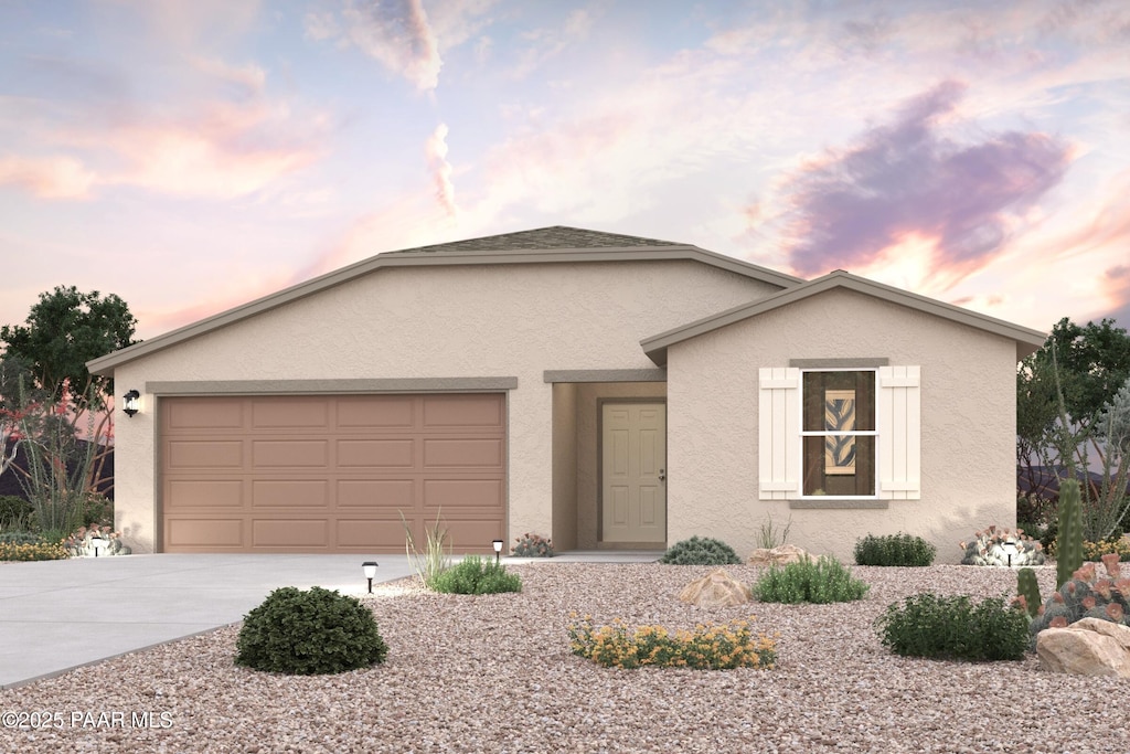 6940 N Wise Maverick Dr, Prescott Valley, AZ 86315 - view of front of home featuring stucco siding, driveway, and a garage