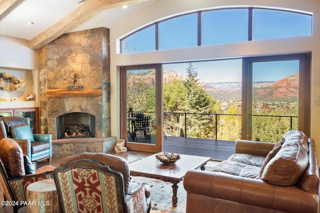 living room featuring a mountain view and a stone fireplace