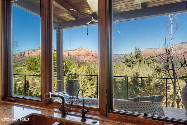 unfurnished sunroom with a mountain view and sink