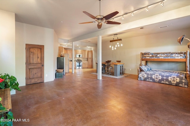 living room featuring ceiling fan with notable chandelier