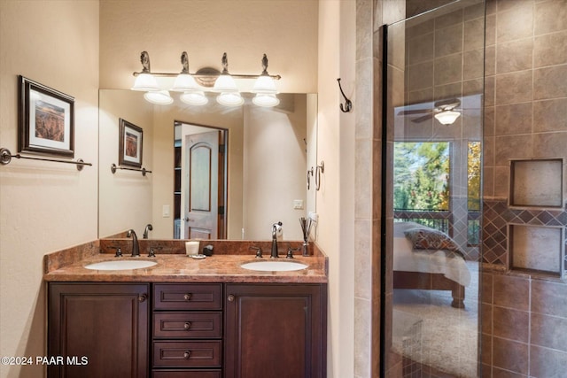 bathroom featuring an enclosed shower, vanity, and ceiling fan