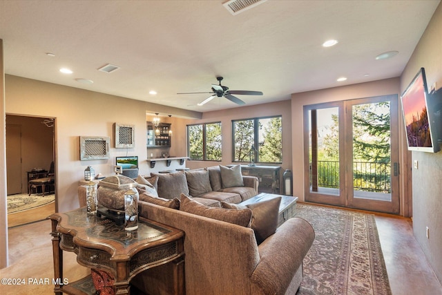 living room featuring a wealth of natural light and ceiling fan