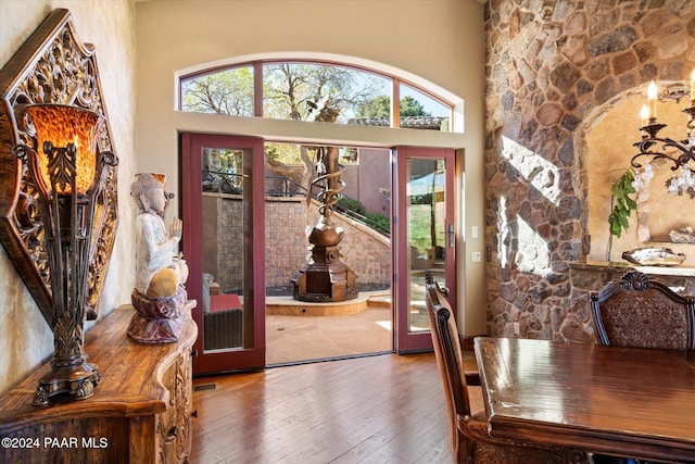 foyer entrance featuring hardwood / wood-style floors and a towering ceiling