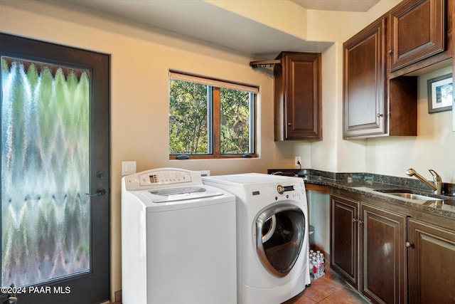 washroom with washer and clothes dryer, cabinets, light tile patterned floors, and sink