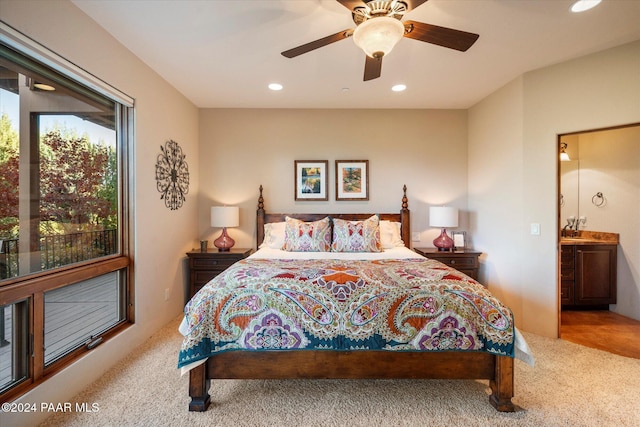 carpeted bedroom featuring ceiling fan and ensuite bathroom