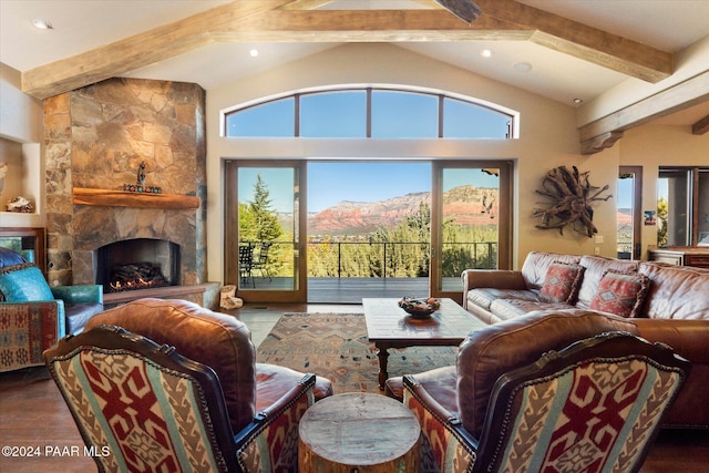 living room with a mountain view, vaulted ceiling with beams, and a fireplace