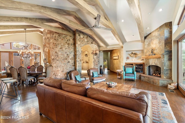 living room featuring a fireplace, a healthy amount of sunlight, dark wood-type flooring, and beamed ceiling