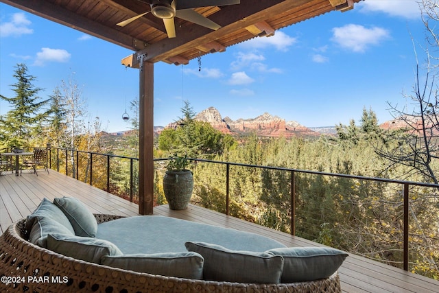 deck featuring a mountain view and ceiling fan