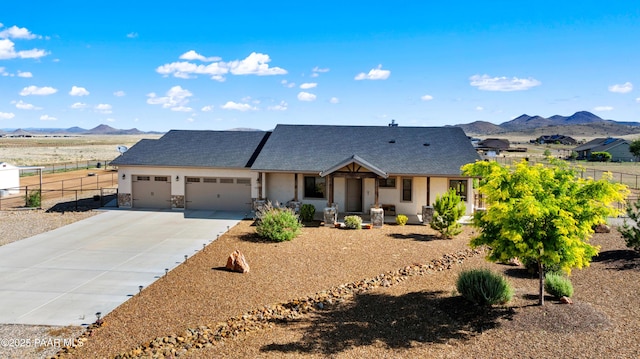 10210 E Dawn To Milky Way, Prescott Valley, AZ 86315 - view of front of house with a mountain view, covered porch, an attached garage, and concrete driveway