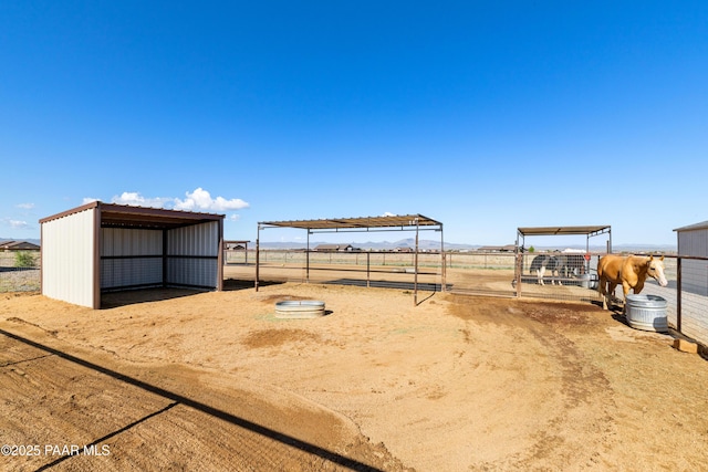 10210 E Dawn To Milky Way, Prescott Valley, AZ 86315 - view of yard featuring an outbuilding, a carport, an exterior structure, and a view of rural / pastoral area
