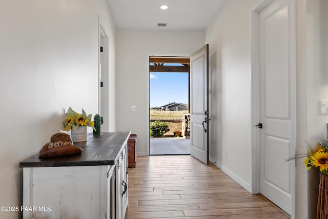 10210 E Dawn To Milky Way, Prescott Valley, AZ 86315 - doorway to outside featuring light wood-style floors, recessed lighting, and baseboards
