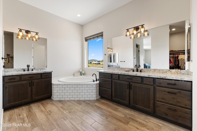 10210 E Dawn To Milky Way, Prescott Valley, AZ 86315 - full bath featuring wood finished floors, a garden tub, and two vanities