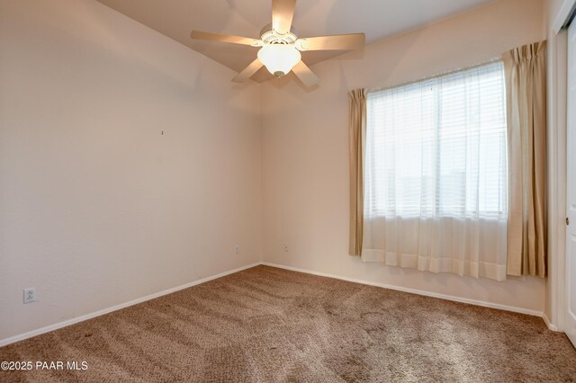 carpeted empty room featuring ceiling fan