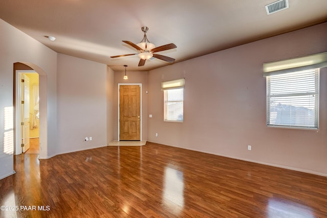 empty room with ceiling fan and hardwood / wood-style floors