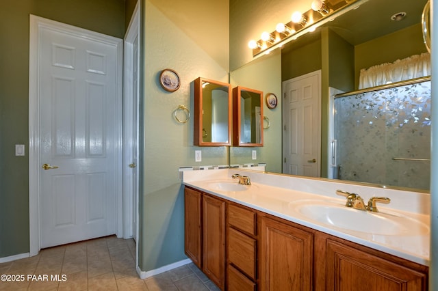 bathroom with vanity, tile patterned flooring, and a shower