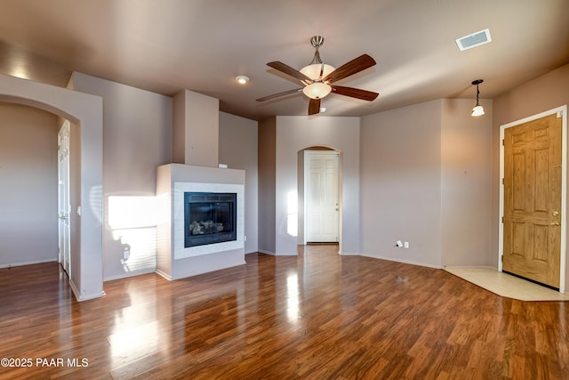 unfurnished living room featuring ceiling fan and wood-type flooring