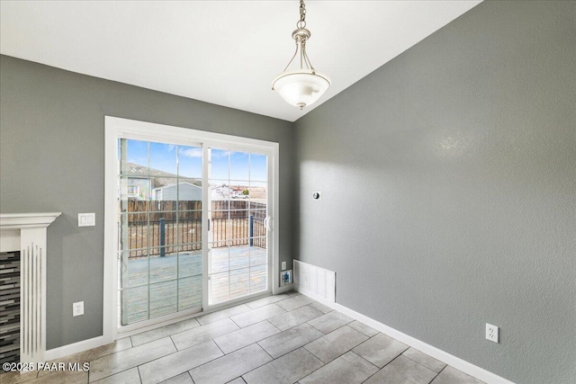 unfurnished dining area with baseboards