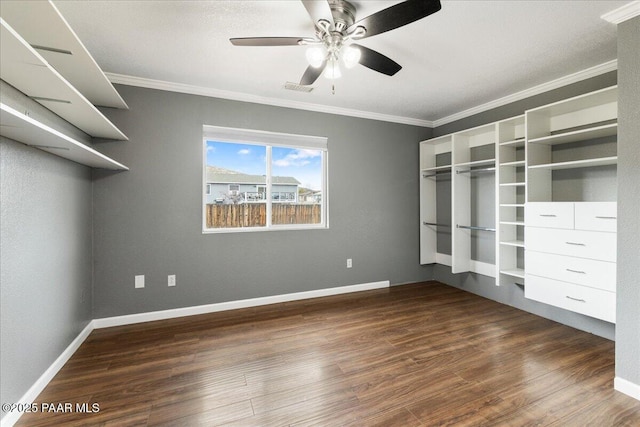 unfurnished bedroom featuring visible vents, wood finished floors, baseboards, and ornamental molding