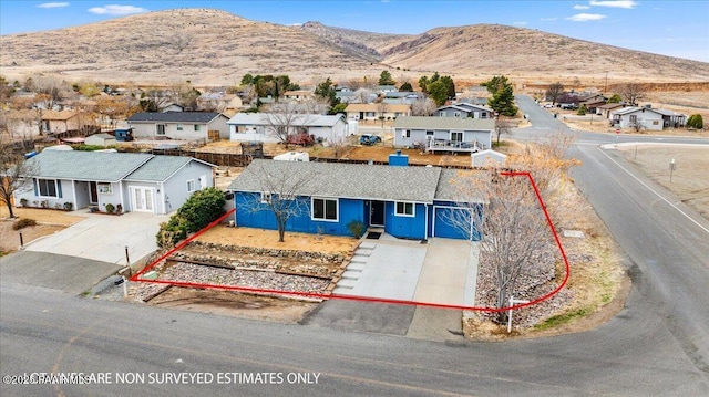 drone / aerial view with a mountain view and a residential view