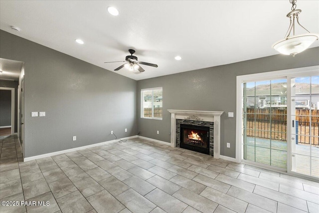 unfurnished living room with recessed lighting, baseboards, a ceiling fan, and a tiled fireplace