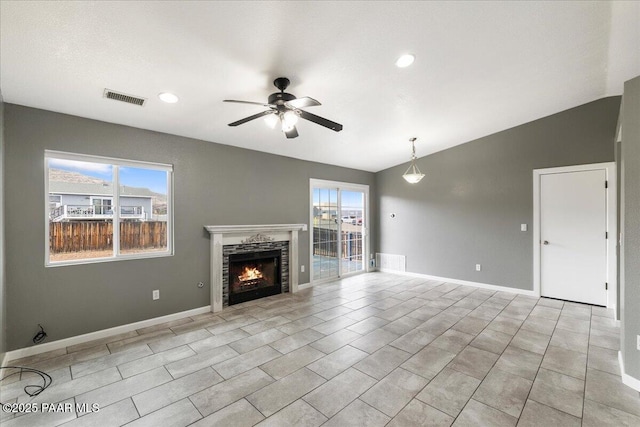 unfurnished living room featuring visible vents, ceiling fan, plenty of natural light, and lofted ceiling