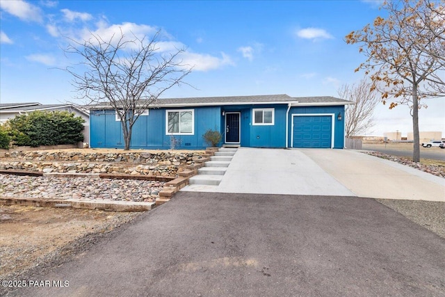 ranch-style home with a garage and driveway