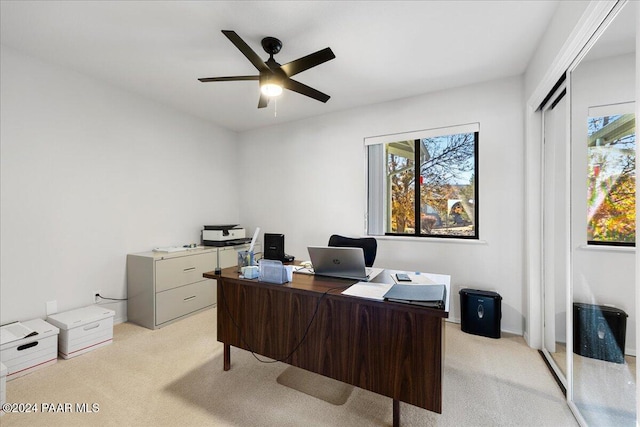 office space with ceiling fan and light colored carpet