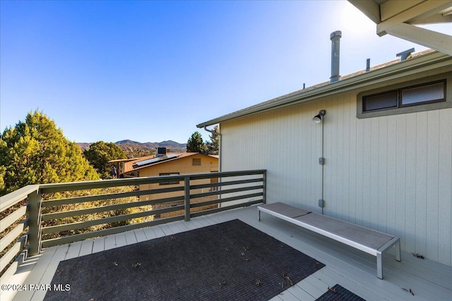 view of patio / terrace with a deck with mountain view