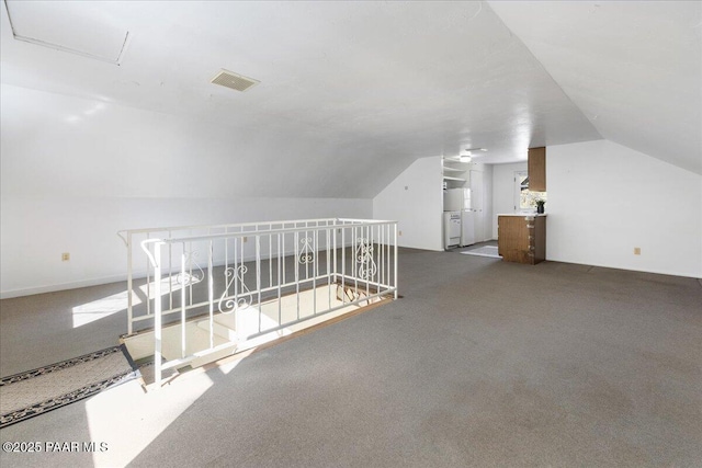 bonus room featuring carpet flooring and vaulted ceiling