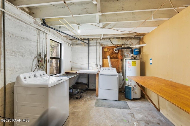 basement with water heater, sink, and washing machine and clothes dryer