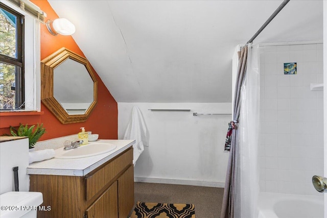 full bathroom with shower / tub combo with curtain, vanity, toilet, and vaulted ceiling