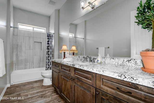 full bathroom with vanity, hardwood / wood-style flooring, toilet, and shower / bathtub combination with curtain