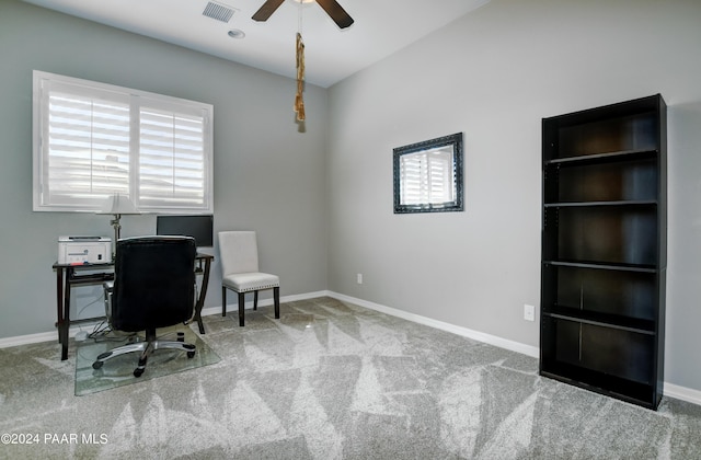 carpeted office space featuring ceiling fan