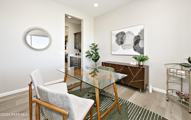 dining room with recessed lighting, light wood finished floors, and baseboards