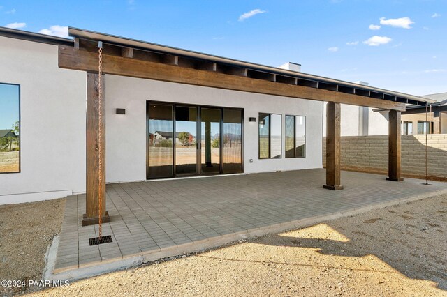 rear view of property featuring a patio area