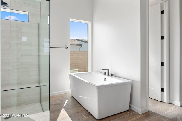 bathroom with plenty of natural light and a tub